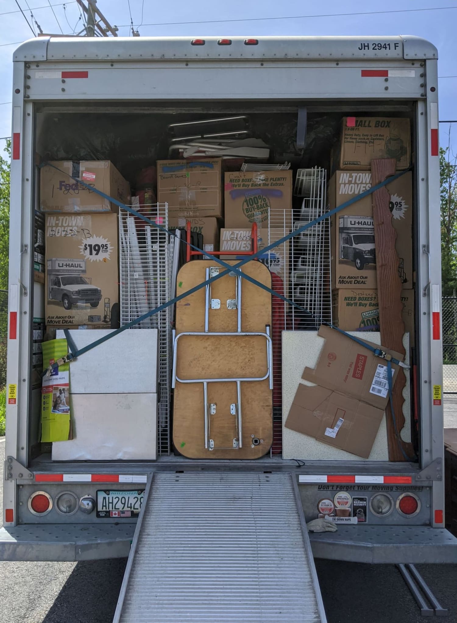 Rental moving truck professionally loaded by Veteran Owned Movers, boxes and furniture secured with straps