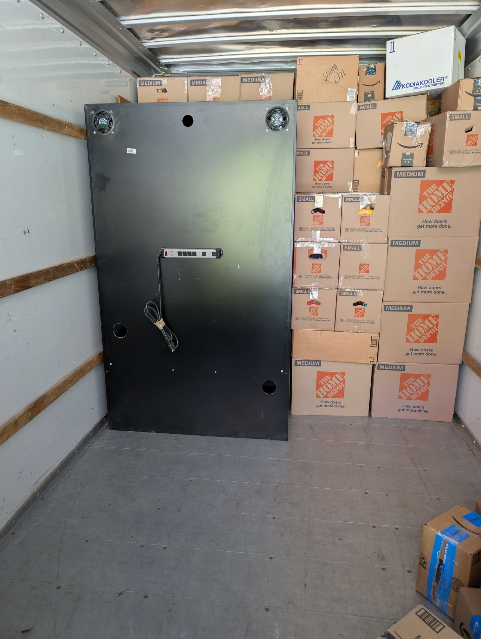 Boxes and totes packed neatly inside a moving truck ready for transport